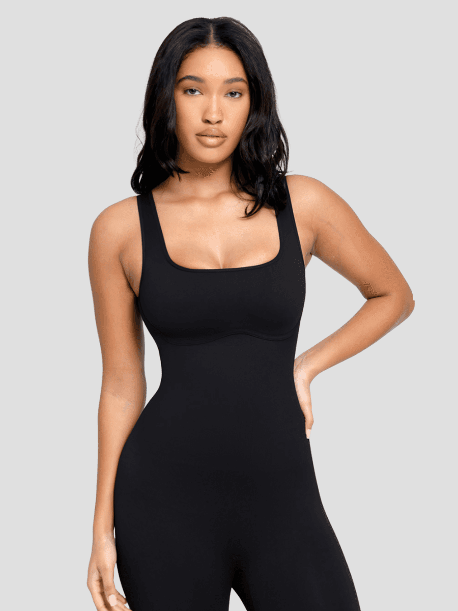 Flared shapewear jumpsuit romper with shaping seamless curve-enhancing design. Square neck, low back, fitted style in black, Outerwear shapewear, shapewear outerwear, Waist cinching, Waist snatching, snatched, Hidden shapwear, built-in shapewear, shapewear technology, stretchy, compression, arm slimming, tummy control, body contouring, best shapewear for women, shapewear on sale, Canadian shapewear brand, skims, spanx, popilush, shapermint. Feelin girl.