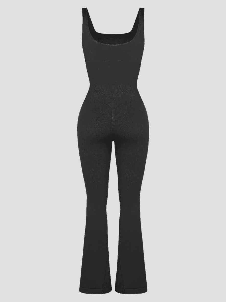 Flared shapewear jumpsuit romper with shaping seamless curve-enhancing design. Square neck, low back, fitted style in black, Outerwear shapewear, shapewear outerwear, Waist cinching, Waist snatching, snatched, Hidden shapwear, built-in shapewear, shapewear technology, stretchy, compression, arm slimming, tummy control, body contouring, best shapewear for women, shapewear on sale, Canadian shapewear brand, skims, spanx, popilush, shapermint. Feelin girl.