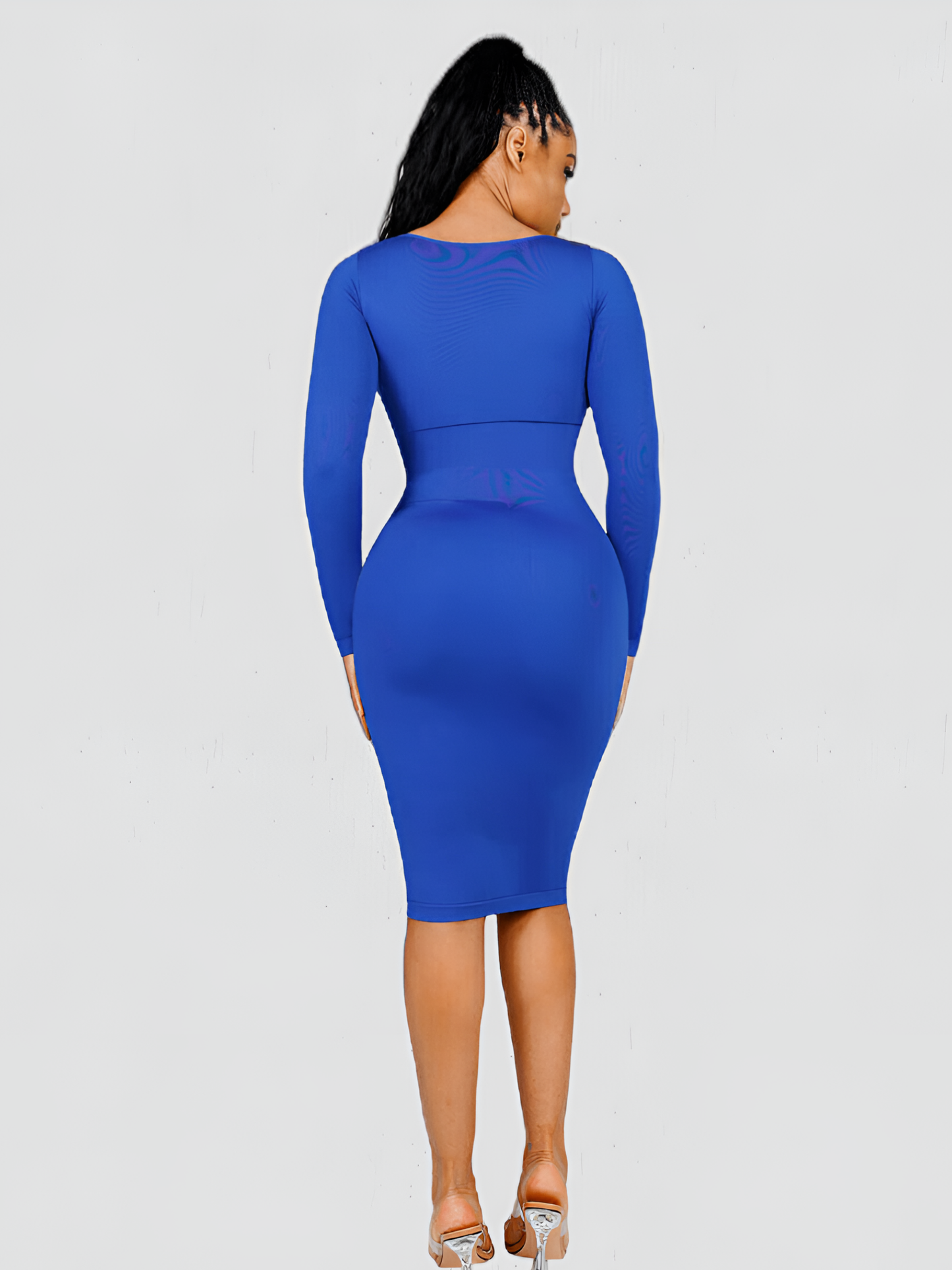 Woman posing from the back wearing a long sleeve blue midi shaping dress by BodyFlexx Shapewear.