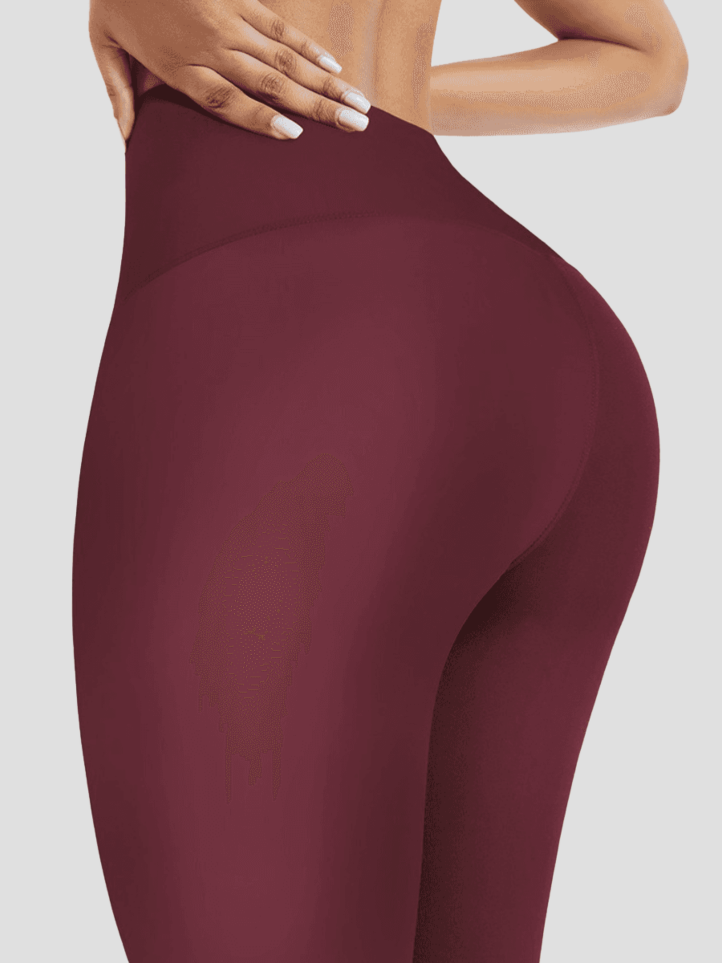 Woman with her hands on her hips wearing red waist-training corset leggings by BodyFlexx Shapewear.