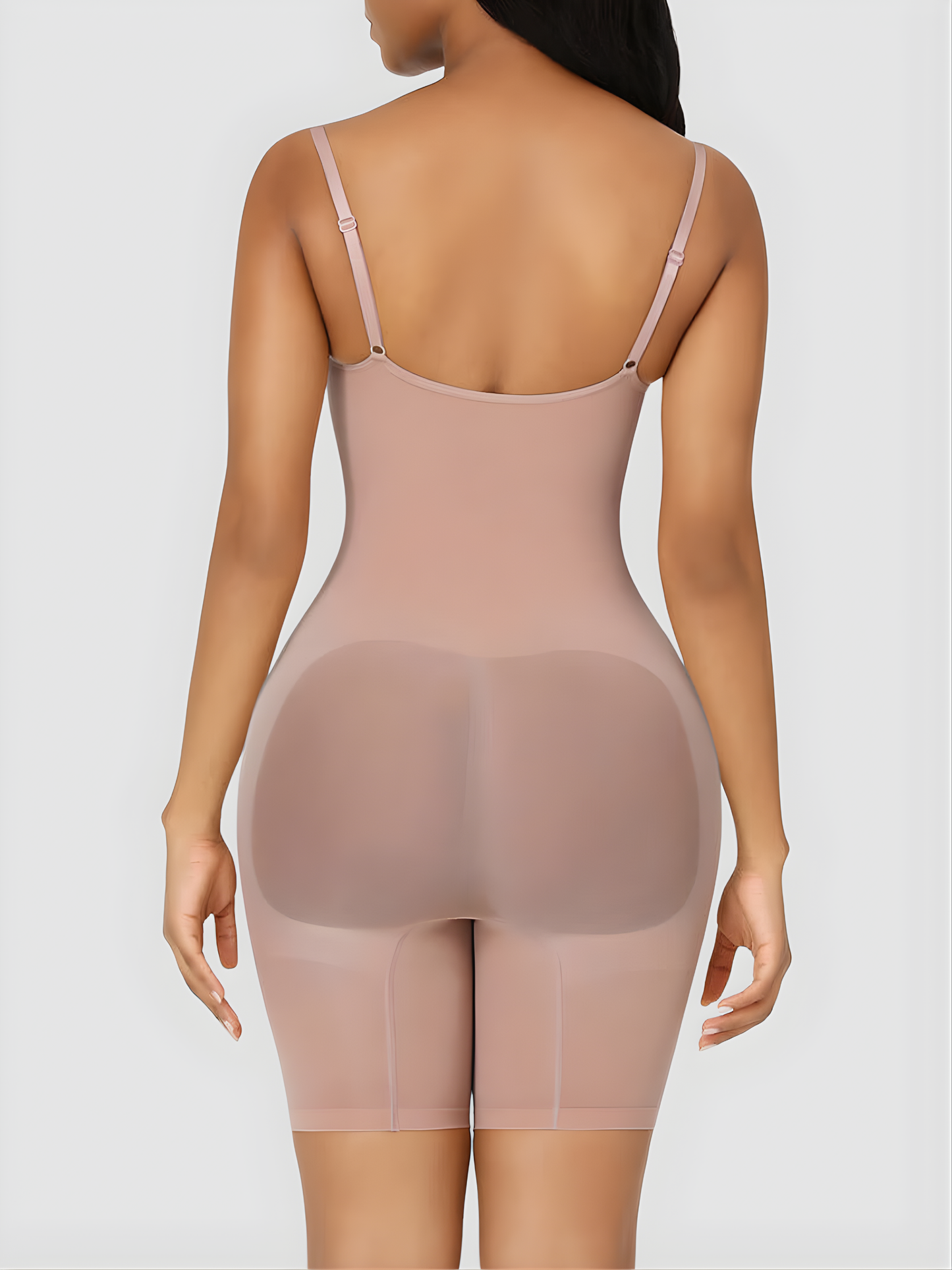 Woman wearing a nude mid-thigh full bodysuit shaper with an open crotch by BodyFlexx Shapewear.