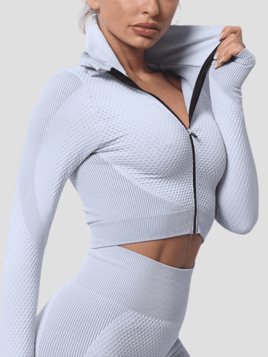 BBL Jacket, Cropped athletic set top with zipper stretchy jacket, workout outfit, athleisure, activewear, activewear sets, workout clothes for women, sweat-wicking, high compression, cellulite smoothing, BBL Jacket, plus size gym outfits, workout wear, gym wear, athletic outfits, nike, under armour, adidas, puma, champion, bombshell activewear, gymshark women, Girlfriend Collective, lululemon, Alo Yoga, Bandier, Athleta, Athletica, Fabletics, Revenge body, grey, gray, silver.