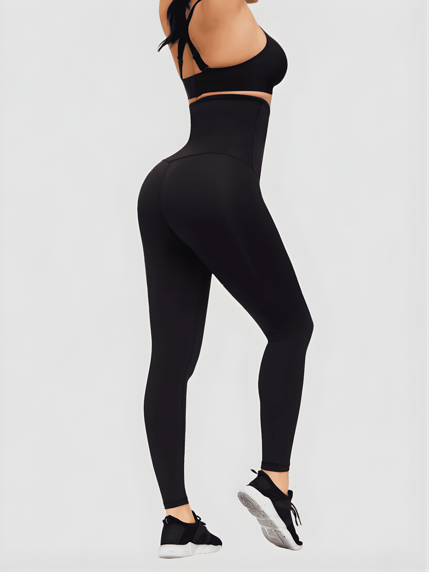 Woman posing in black ultra-high waist-training corset leggings showing off her cellulite-free curves.