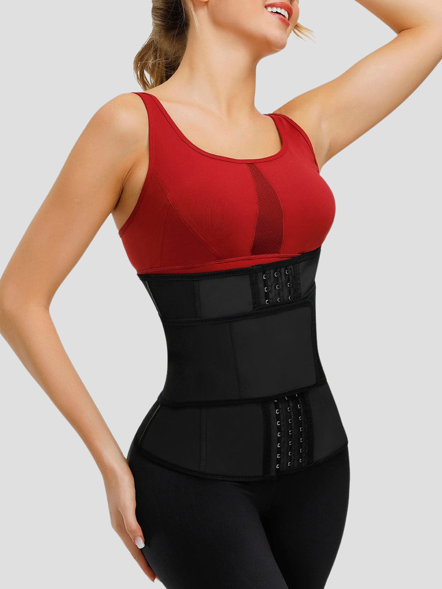 A young woman wearing a black sauna waist trainer with a corset-style hook-and-eye closure and a read shirt.
