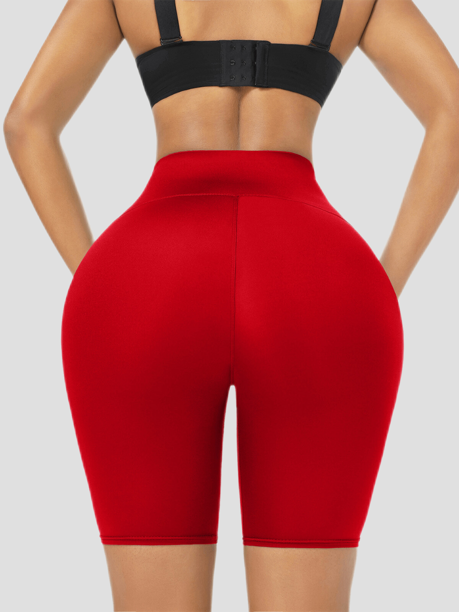 Close up of red sauna weight loss shorts from the back view worn by a young woman.