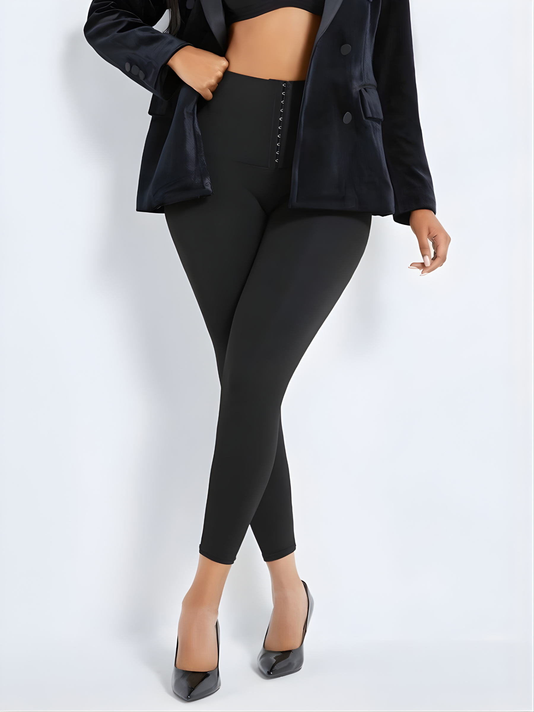Woman wearing black waist training corset leggings by BodyFlexx Shapewear with a black jacket.