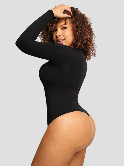 Woman posing wearing a black long-sleeve shaping bodysuit by BodyFlexx Shapewear.
