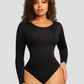 Woman wearing a black long-sleeve shaping bodysuit by BodyFlexx Shapewear.