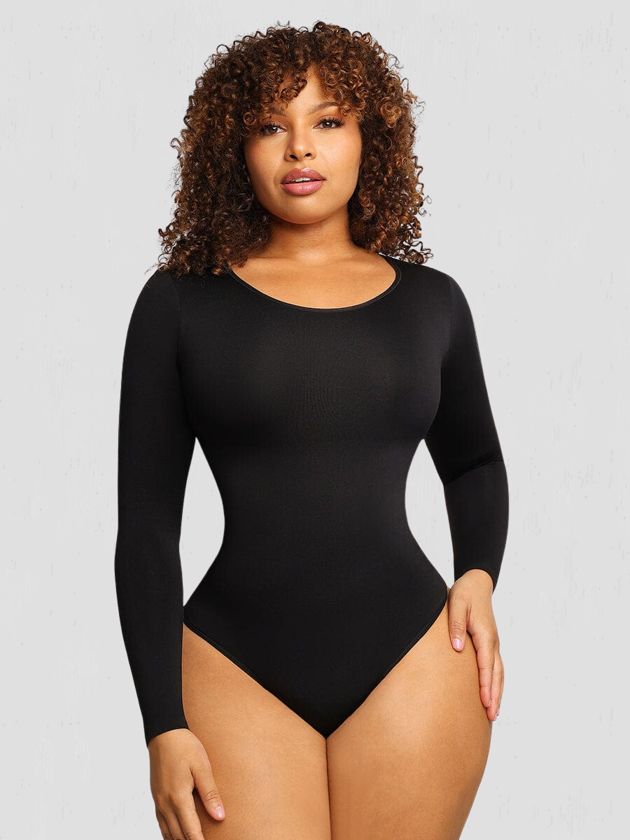 Woman wearing a black long-sleeve shaping bodysuit by BodyFlexx Shapewear.