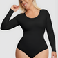Smiling woman wearing a black long-sleeve bodysuit with built-in shapewear by BodyFlexx.