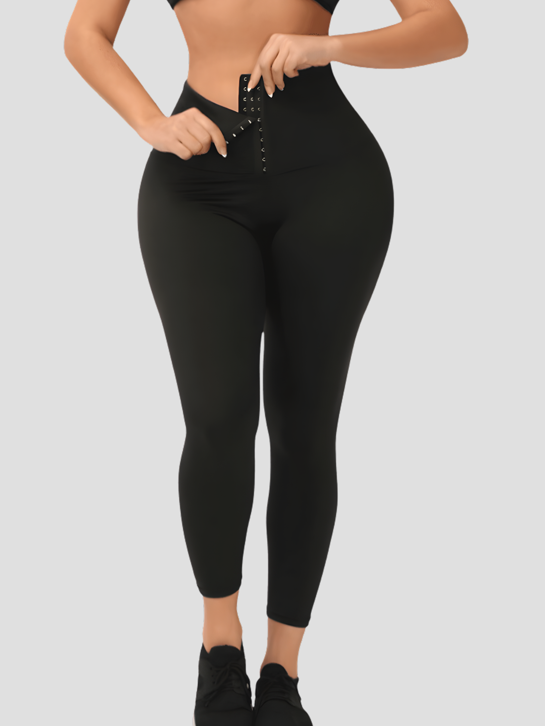Woman wearing black waist training leggings with a corset closure designed for tummy-control and cellulite-smoothing by BodyFlexx Shapewear.
