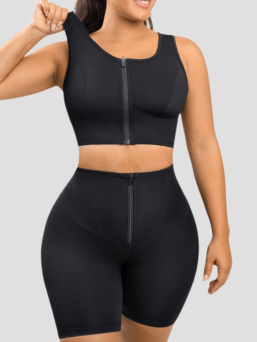 A woman wearing a black full coverage sports bra activewear top designed with removable bra padding and back support ease pain and provide posture correction.