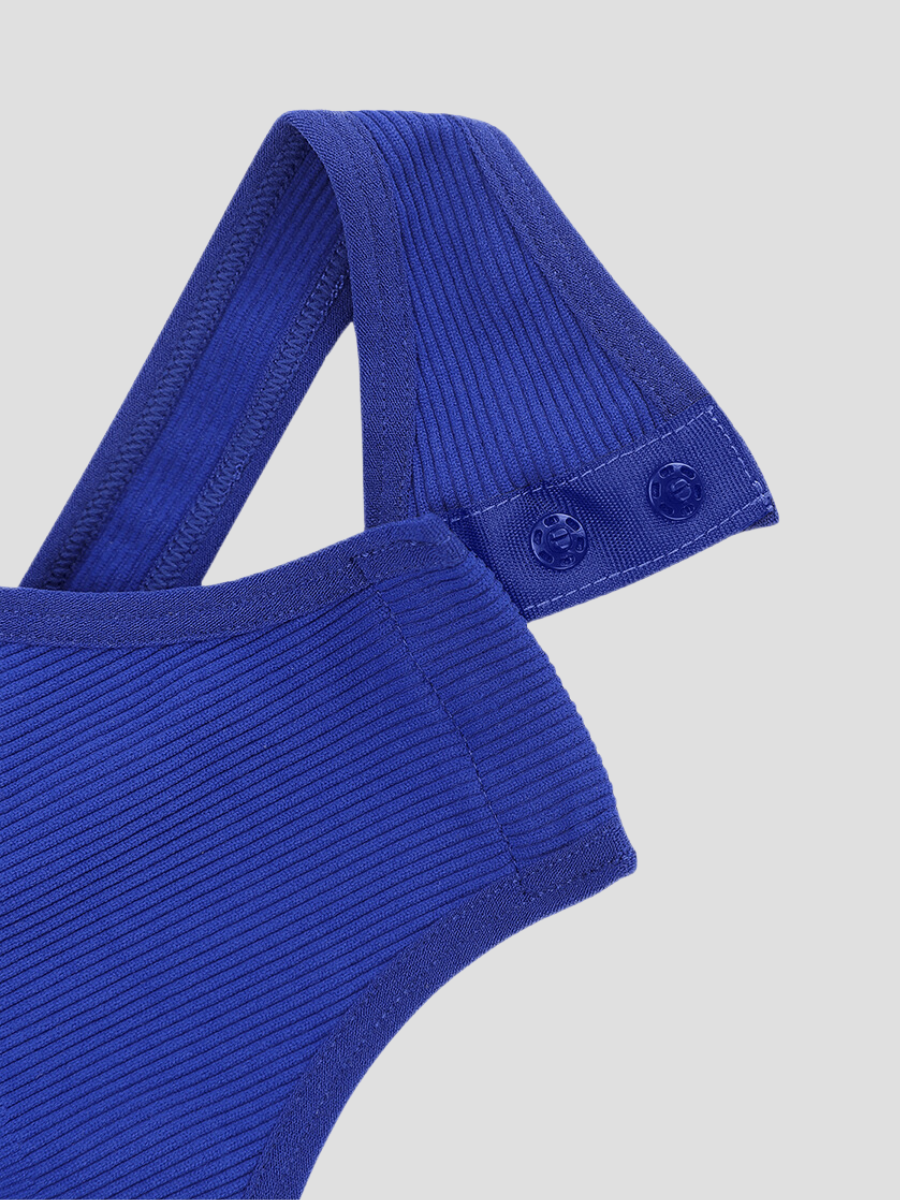 A close-up of the triple buttoned crotch design on a blue off-the-shoulder asymmetric sleeveless shapewear bodysuit with built-in tummy control.