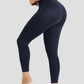 Woman posing in blue high waisted corset leggings for tummy-control and cellulite-smoothing by BodyFlexx Shapewear.