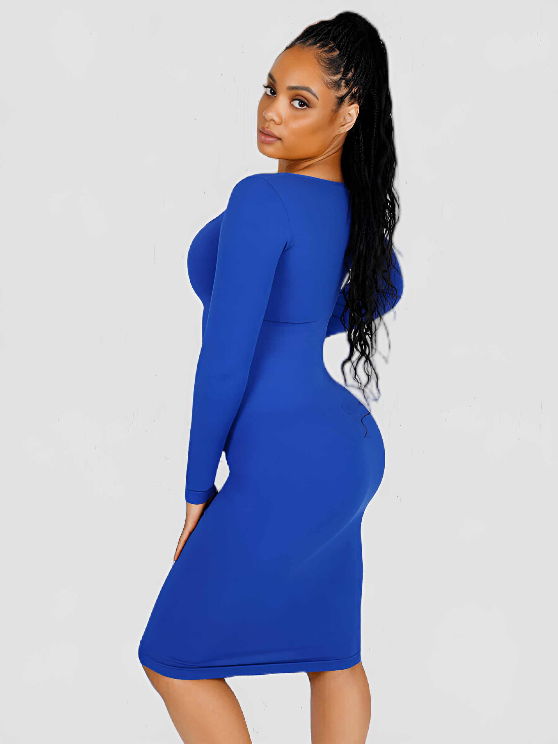 Woman wearing a blue long sleeve midi shaping dress by BodyFlexx Shapewear.