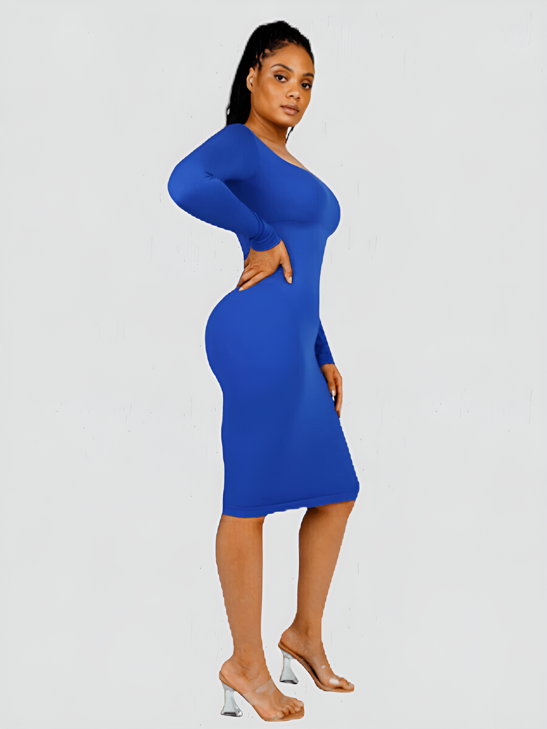 Woman wearing a long sleeve blue midi shaping dress by BodyFlexx Shapewear.