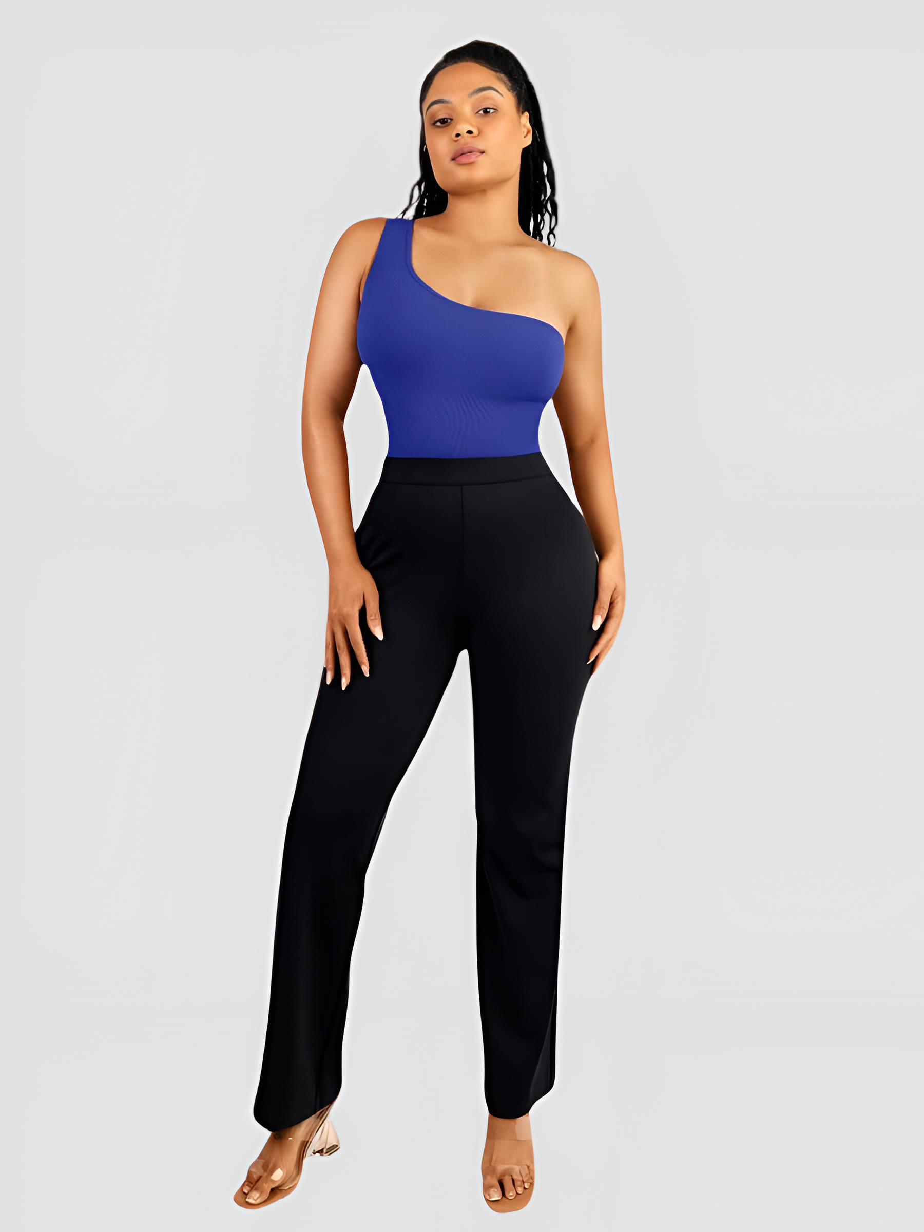 A woman wearing a blue off-the-shoulder sleeveless shaping bodysuit with built-in tummy-control shapewear paired with black pants.