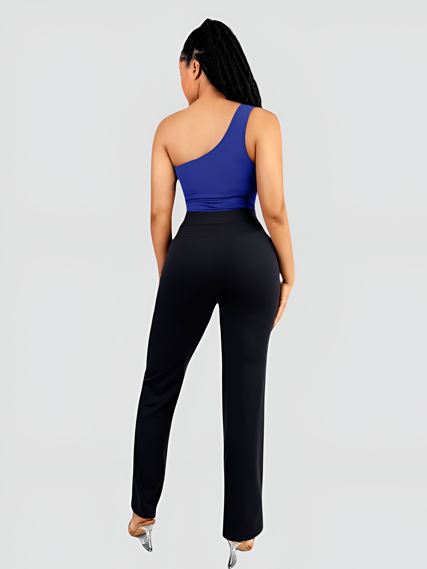 A woman posing wearing a blue off-the-shoulder shaping bodysuit by BodyFlexx and black pants with built-in tummy-control shapewear paired with black pants.
