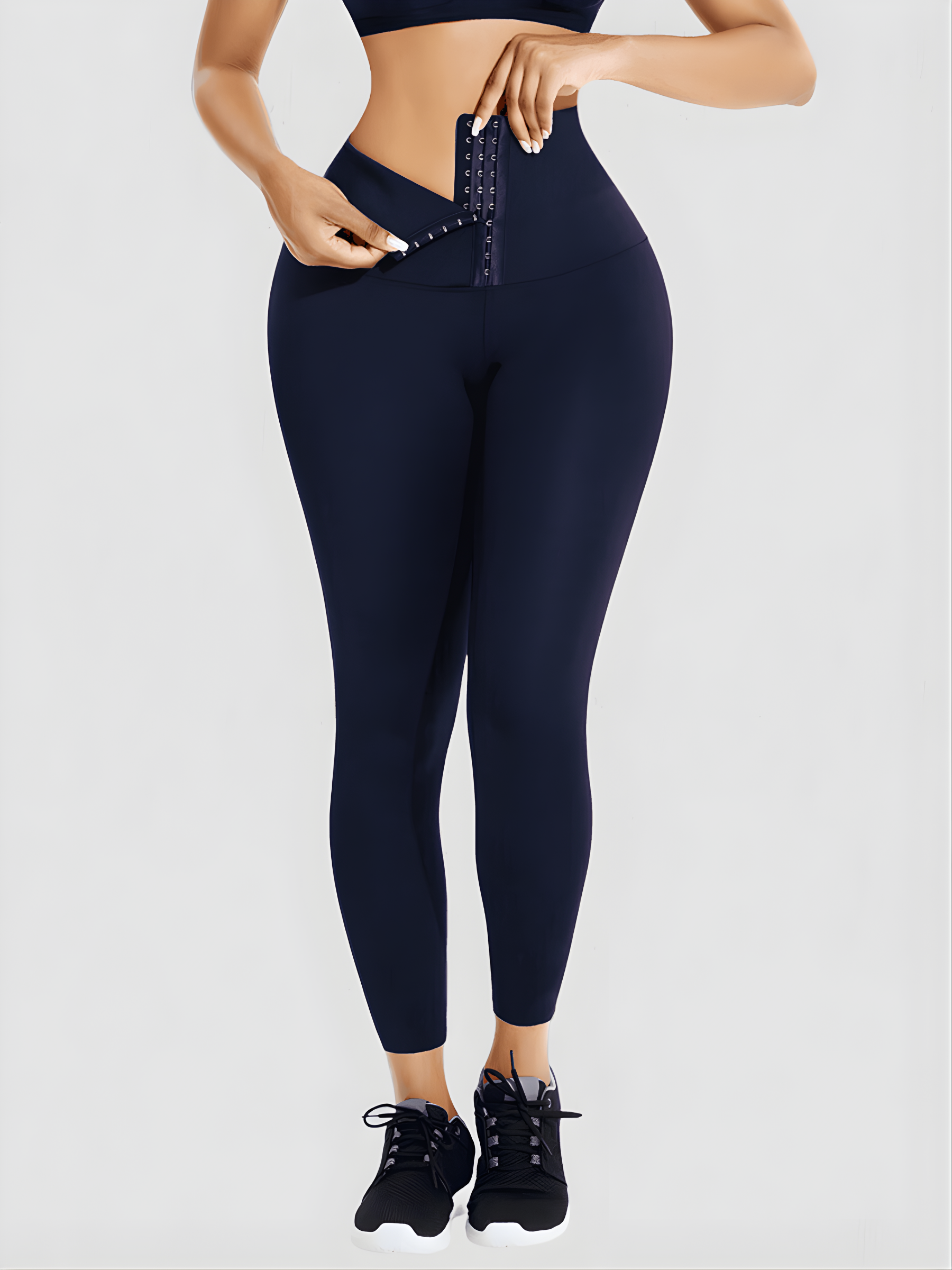 Woman wearing high waisted blue waist training leggings with a 3 row hook-and-eye corset closure by BodyFlexx Shapewear.