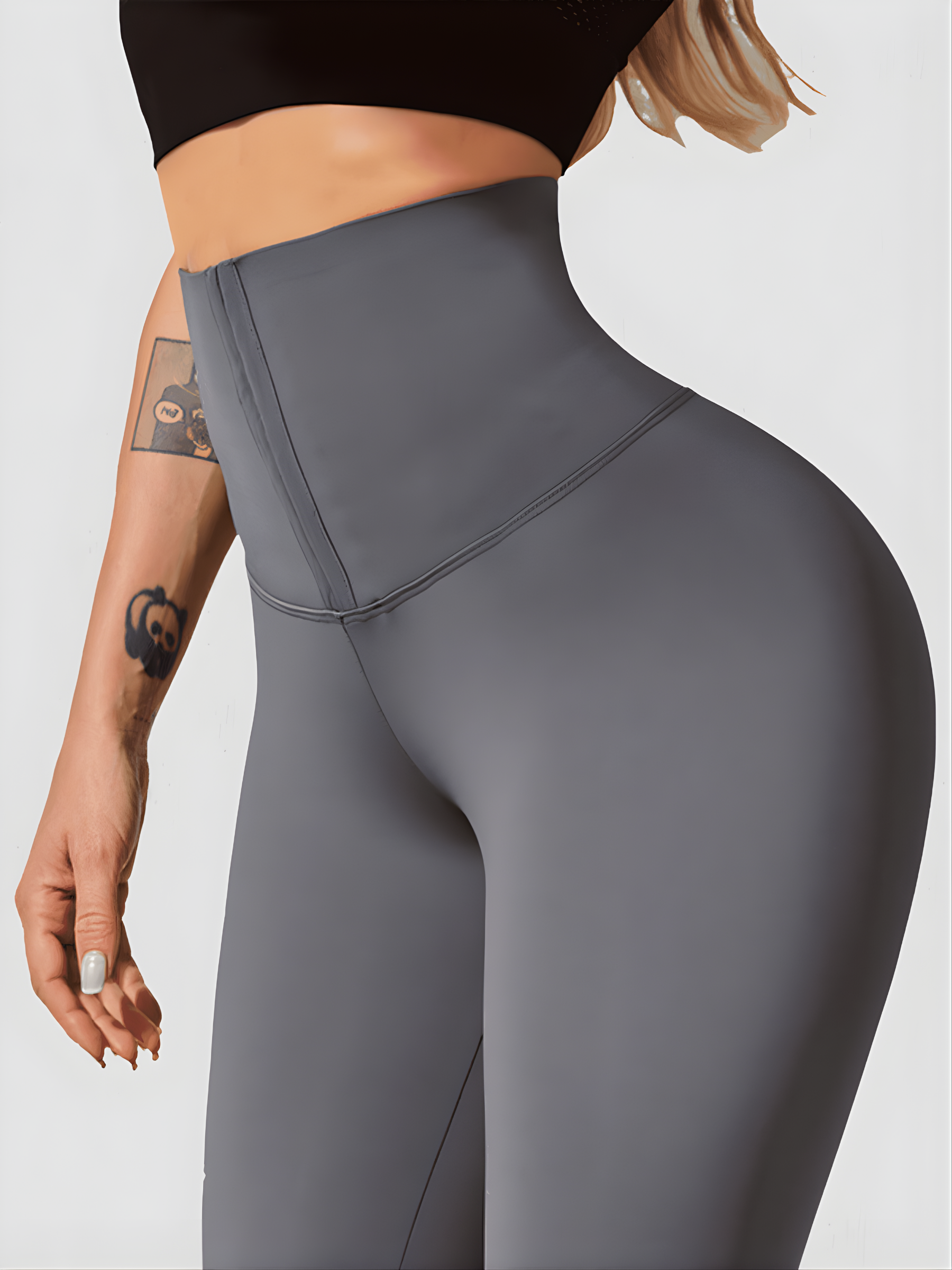 Woman wearing gray waist training leggings with a corset closure designed for tummy-control and cellulite-smoothing by BodyFlexx Shapewear.