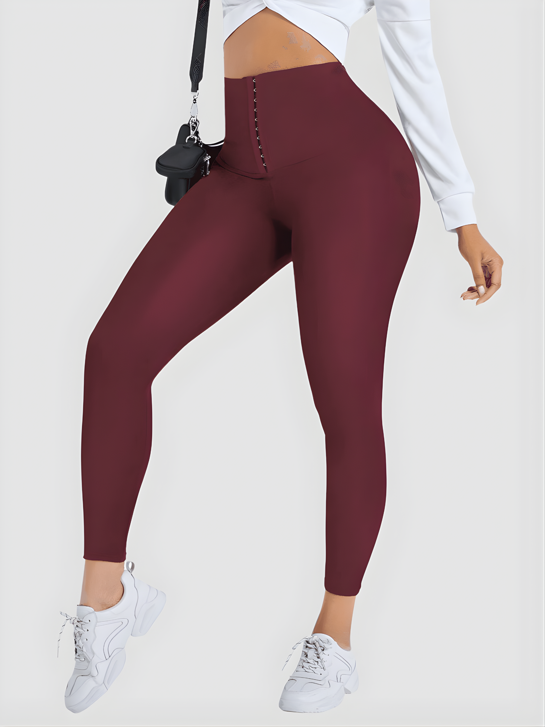 Woman posing wearing red waist training corset leggings by BodyFlexx Shapewear and a white blouse.