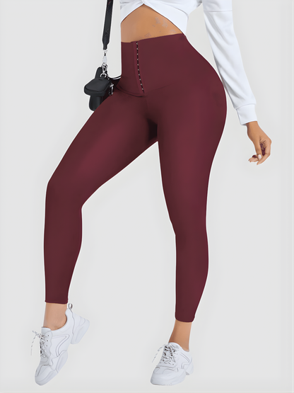Woman posing wearing red waist training corset leggings by BodyFlexx Shapewear and a white blouse.