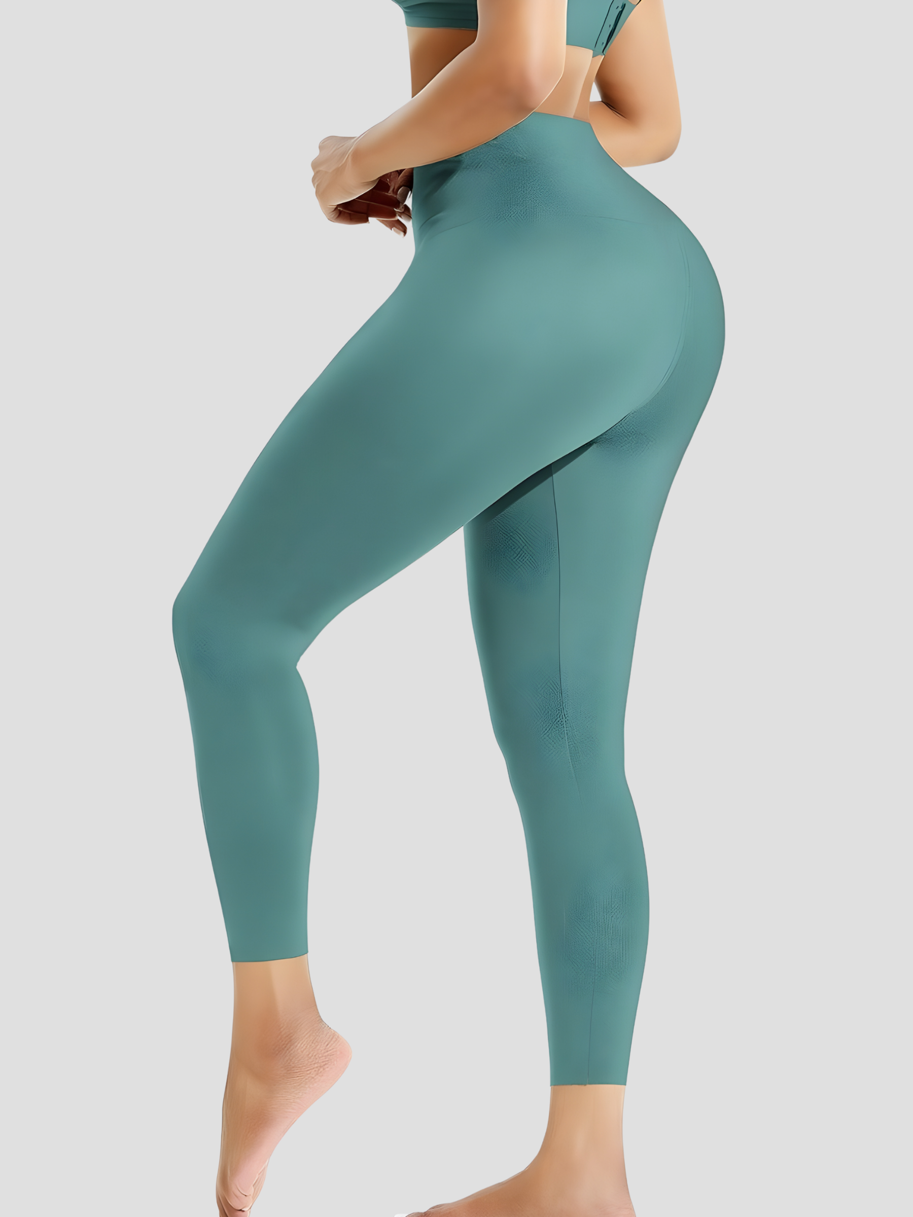 Woman posing wearing high waisted teal blue waist training leggings with a 3 row hook-and-eye corset closure by BodyFlexx Shapewear.