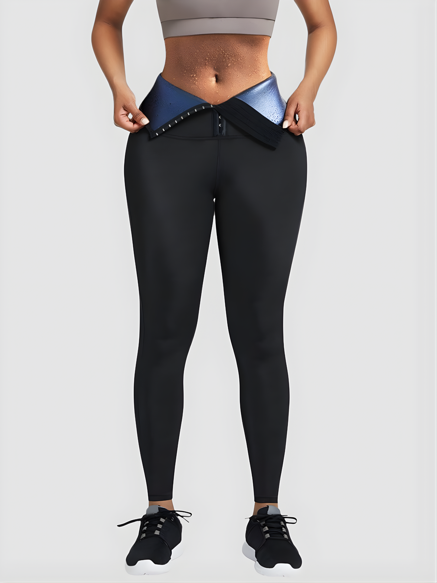 Woman wearing BodyFlexx Waist-Training Sauna Leggings with a corset closure showing a sweaty stomach after a workout.