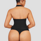 Woman wearing a black halter-style shapewear bodysuit with built-in removable bra padding and seamless thong design. She is posing showing the back view.