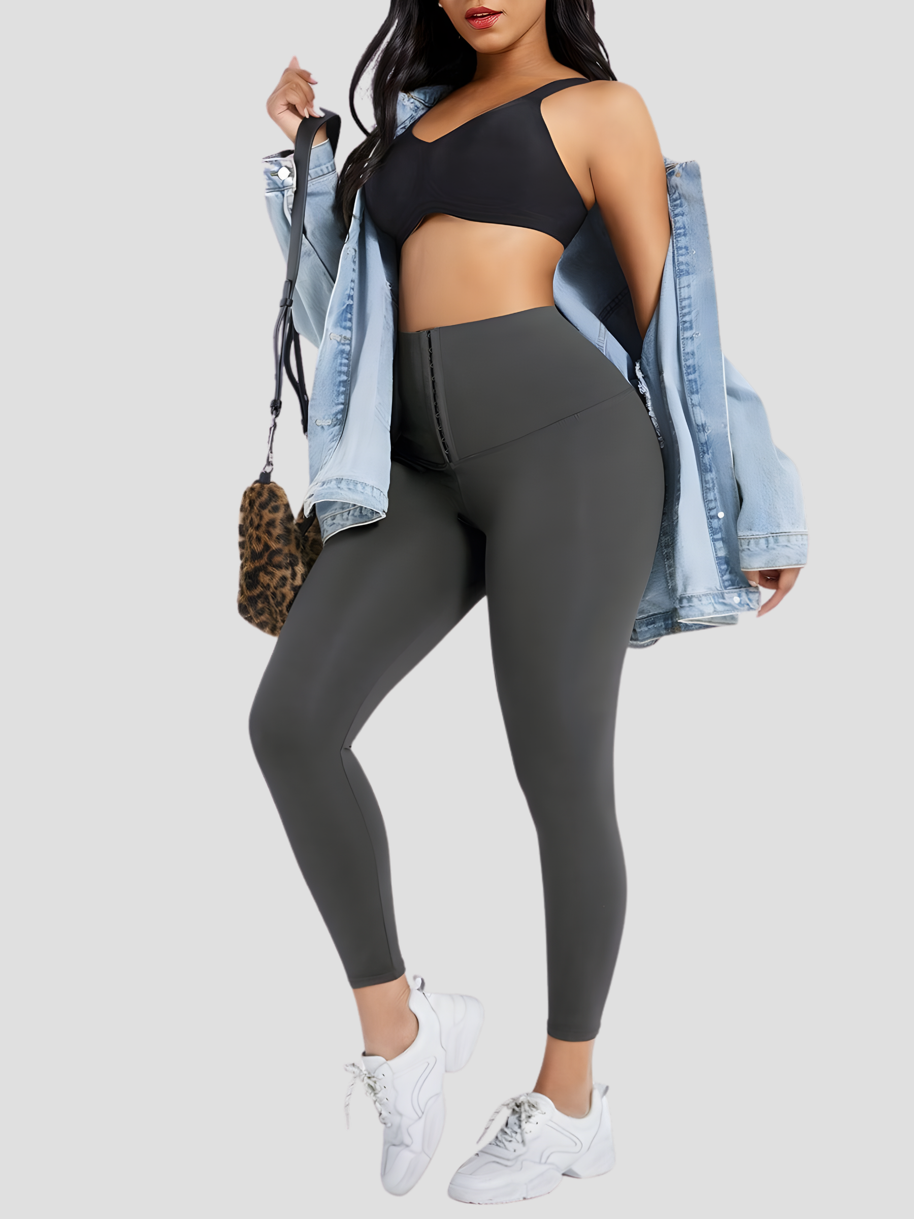 Woman wearing gray waist-training corset leggings by BodyFlexx Shapewear with a jean jacket.