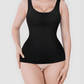 Woman wearing a black shapewear tank top by BodyFlexx on a white background.