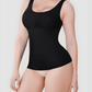 Woman wearing a black shaping tank top by BodyFlexx Shapewear and beige underwear showing off her curves.