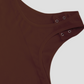 Close-up of the triple button crotch closure designed for bathroom convenience on a brown halter shapewear bodysuit.