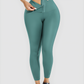 Woman wearing teal blue high waisted corset leggings with a corset closure designed for tummy-control and cellulite-smoothing by BodyFlexx Shapewear.
