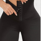Woman wearing black waist trainer leggings with a corset closure designed for tummy-control and cellulite-smoothing by BodyFlexx Shapewear.
