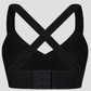 Close up of a wireless, seamless black t-shirt bra from the back with wide adjustable straps and removable padding.