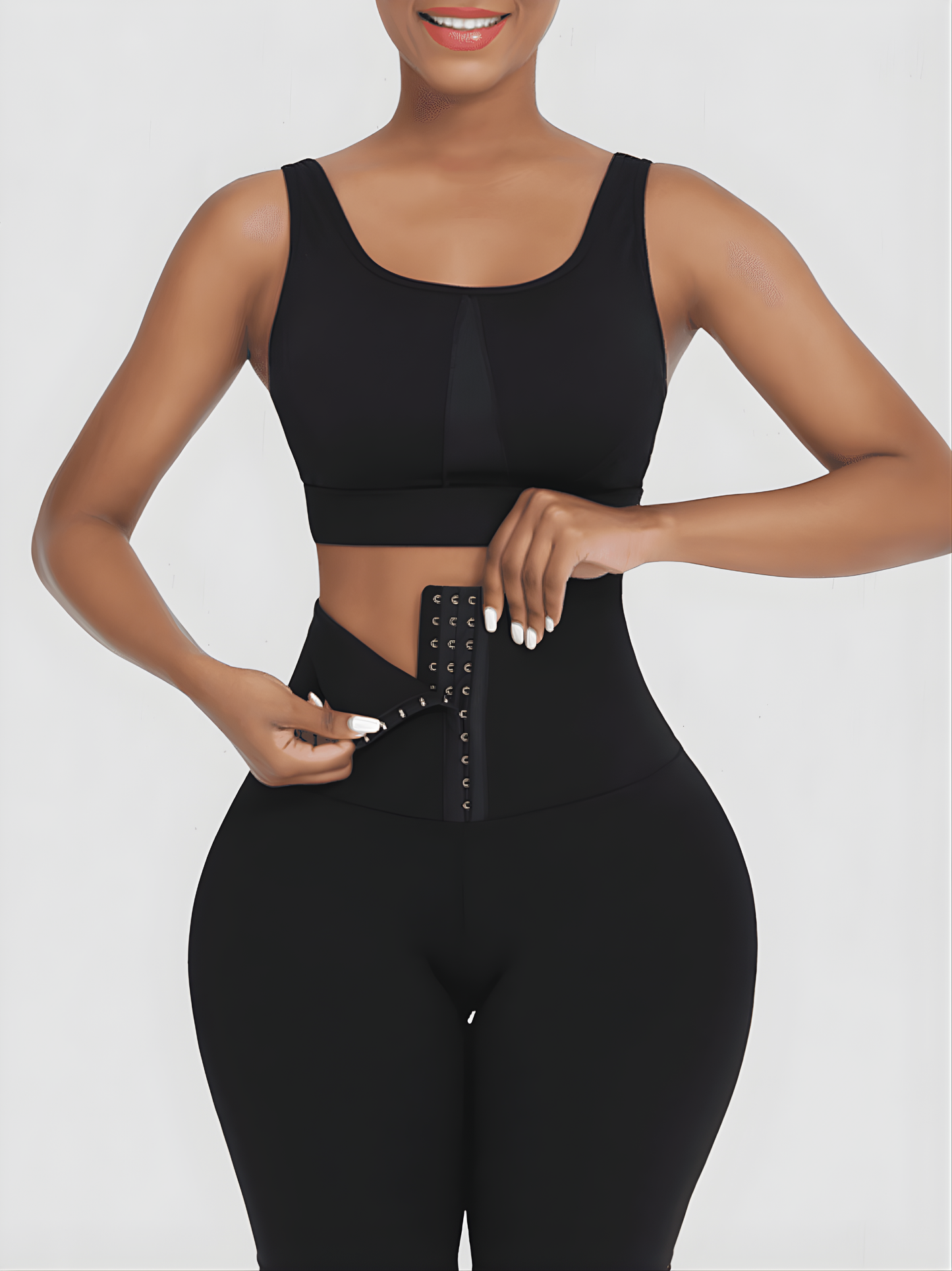 Woman wearing black waist training leggings with a corset closure designed for tummy-control and cellulite-smoothing by BodyFlexx Shapewear.