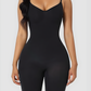 Model wearing a black mid-thigh bodysuit shaper by BodyFlexx Shapewear.