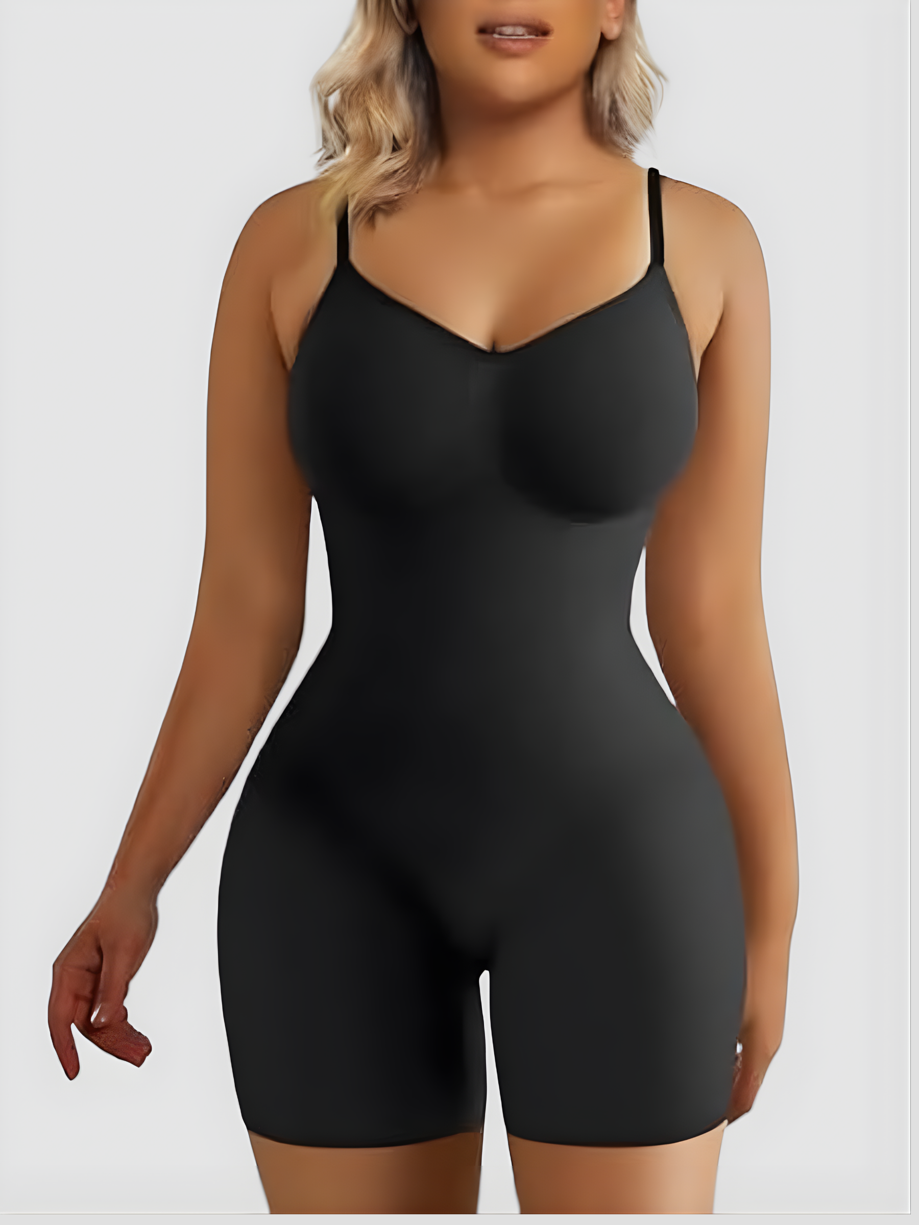 Woman wearing a black high compression mid-thigh bodysuit shaper by BodyFlexx Shapewear.