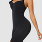 Woman wearing a black mid-thigh bodysuit shaper by BodyFlexx Shapewear.