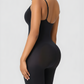 Woman wearing a black mid-thigh bodysuit shaper by BodyFlexx showing off her curves.