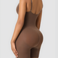 Woman wearing a brown mid-thigh bodysuit shaper by showing off her curves.