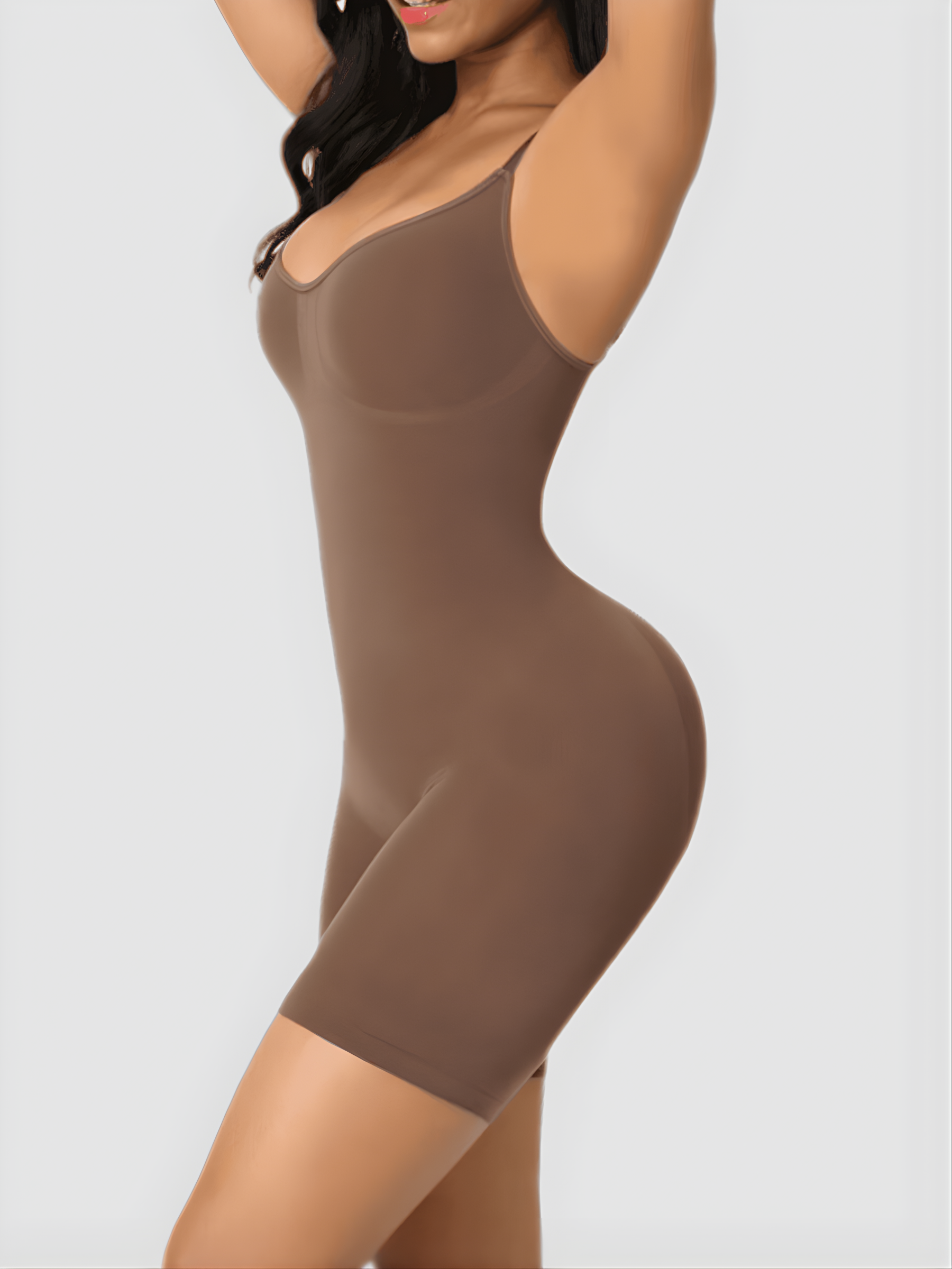 Woman wearing a good quality brown shapewear bodysuit flaunting her curves.