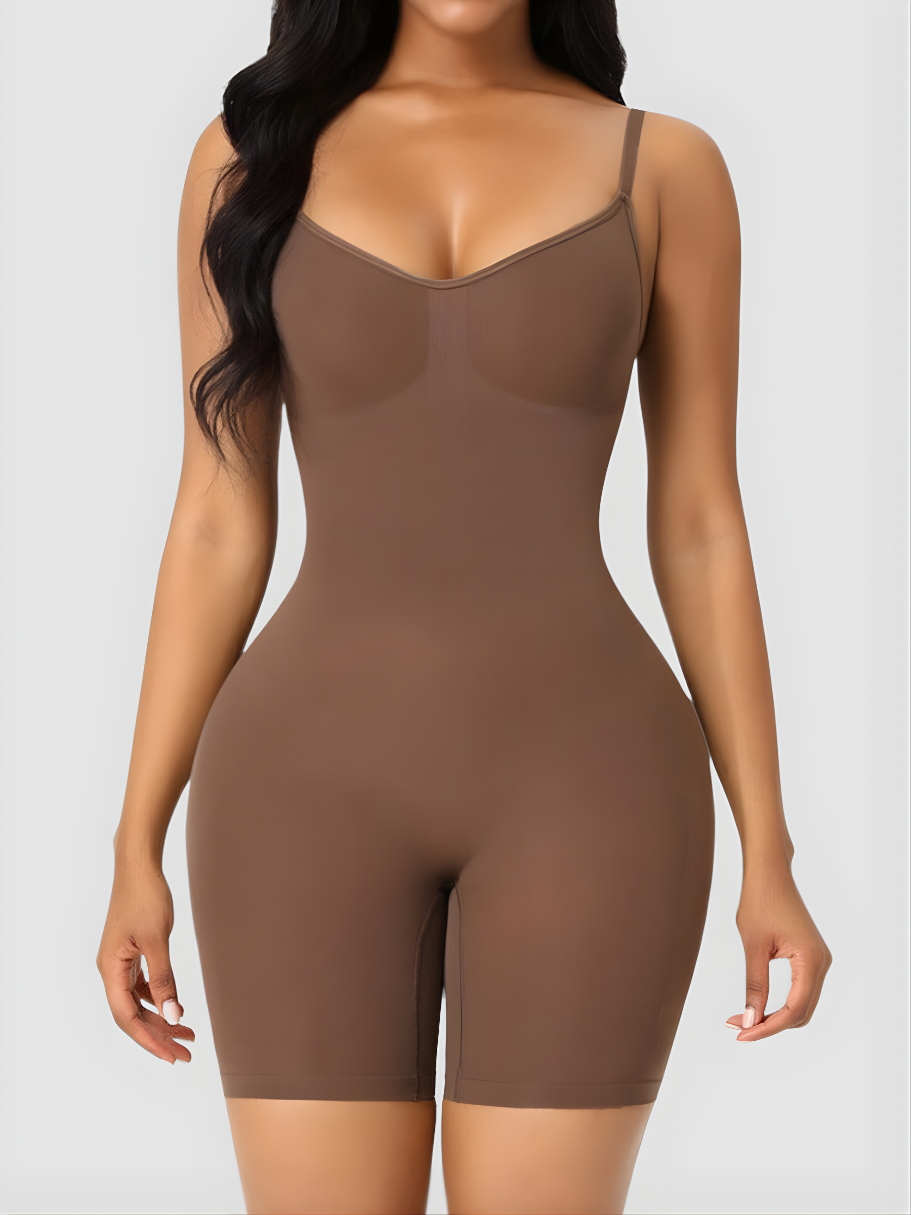 Model wearing a mid-thigh brown bodysuit shapewear garment.