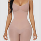 Woman wearing a nude mid-thigh bodysuit shapewear garment with an  BodyFlexx.