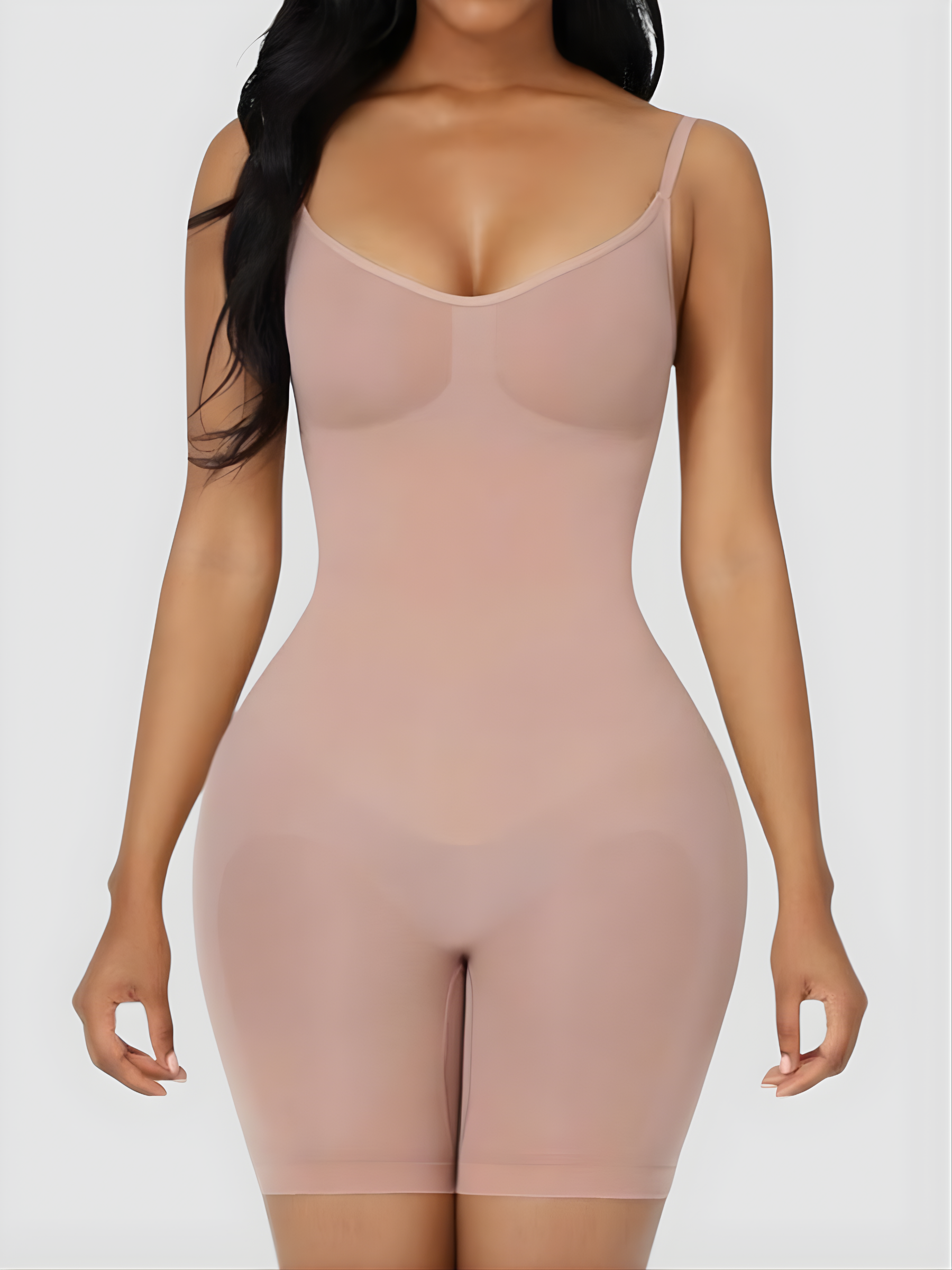 Woman wearing a nude mid-thigh bodysuit shapewear garment with an  BodyFlexx.