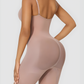 Woman wearing a nude mid-thigh shapewear bodysuit by BodyFlexx Shapewear.