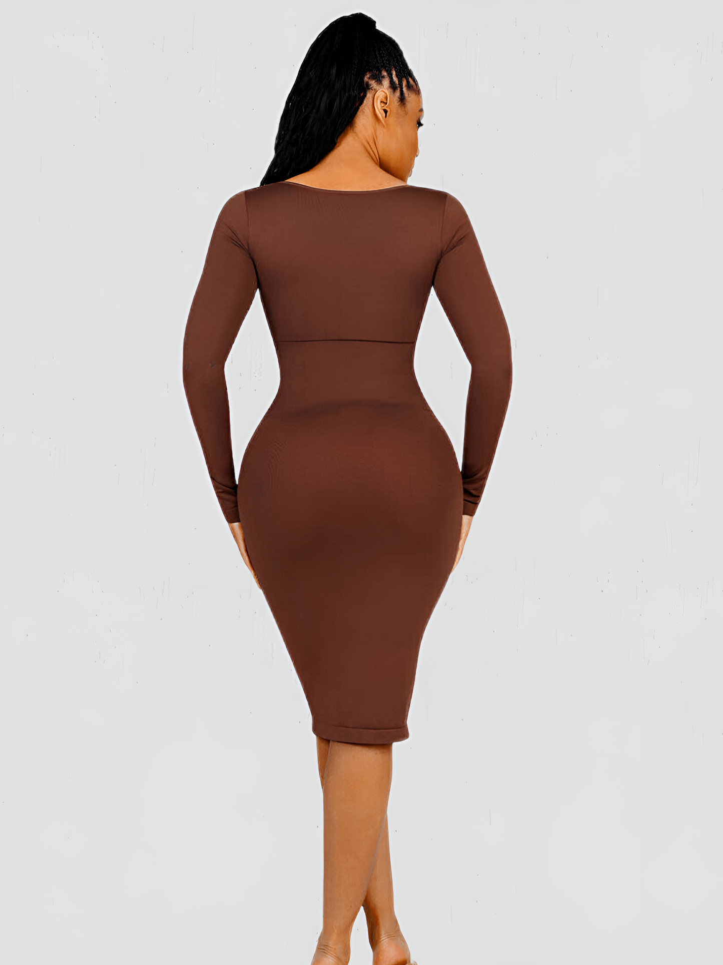Woman wearing a long sleeve brown midi shaping dress by BodyFlexx Shapewear.
