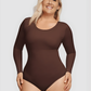 Woman wearing a brown long-sleeve shaping bodysuit by BodyFlexx Shapewear.