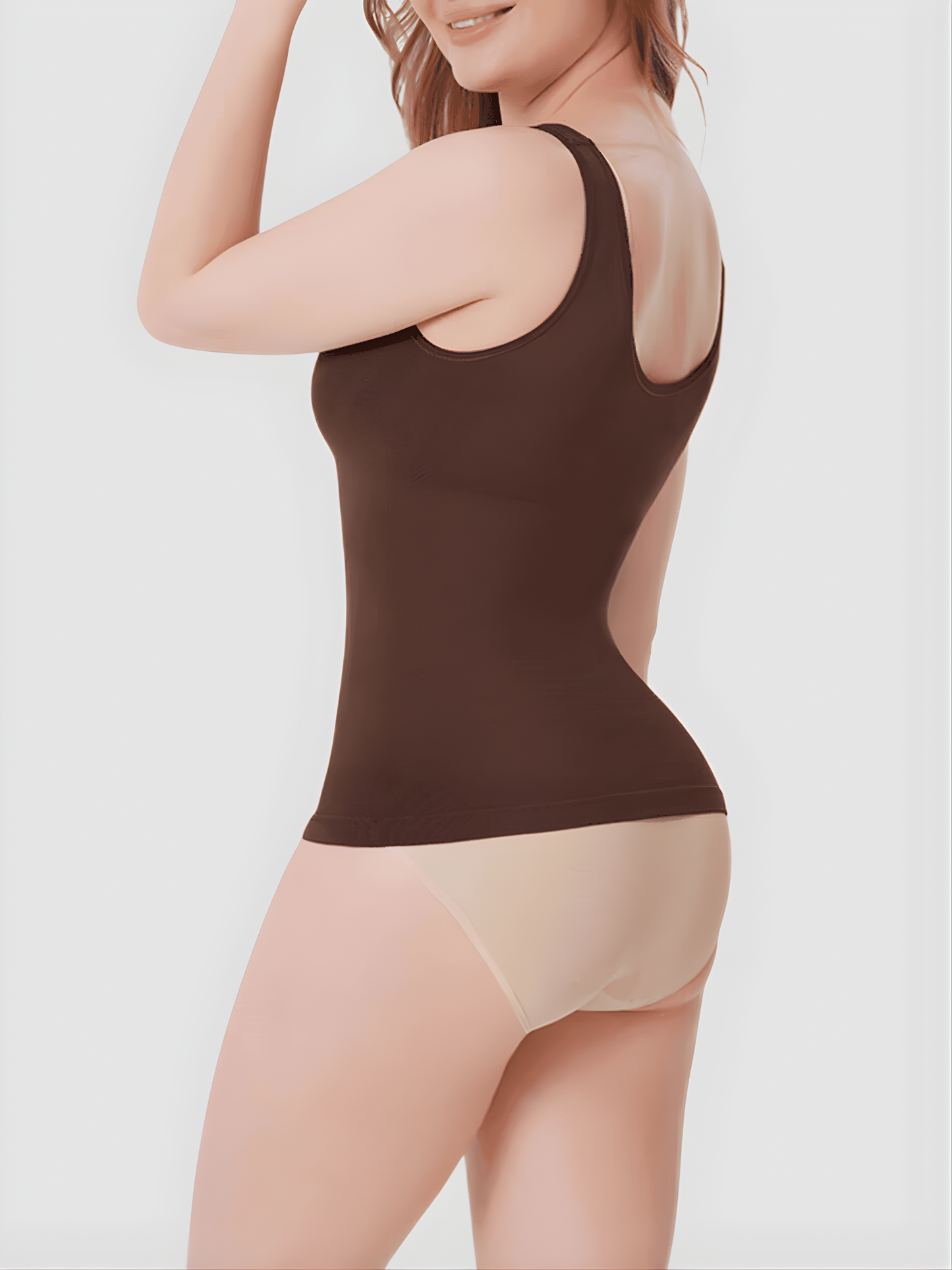Woman wearing a brown shaping tank top by BodyFlexx Shapewear and beige underwear.